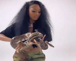 Abby is a brave girl and doesn't afraid to hold even a big python.
